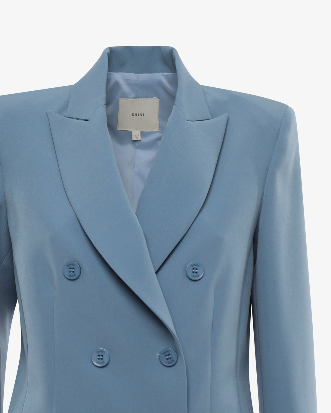 Tailleur in tessuto tecnico con giacca doppiopetto e pantalone flare